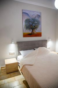 a bedroom with a bed and a painting on the wall at Minimal House in Paralia Katerinis