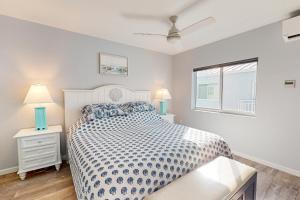 a bedroom with a bed and two night stands with lamps at Ocean Isles #28 in Marathon +36 photos