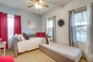 a living room with two beds and a ceiling fan at 1 Mi to Empire Polo Club Spacious Indio Home! in Indio +33 photos