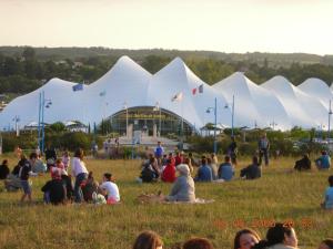 a crowd of people sitting in a field in front of a building at Au Bon Accueil in Jonzac +7 photos