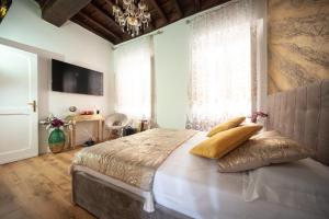 a bedroom with a large bed and a chandelier at Pantheon Charming Accommodation in Rome