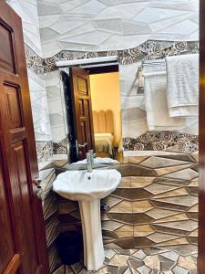 a bathroom with a sink and a mirror at Oceans-Opulence/3BR-5 BEDS in Dar es Salaam