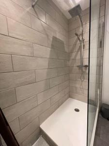 a bathroom with a shower with a glass door at L’appartement charmant in Beynost