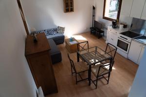 a living room with a couch and a table and chairs at La maison sur la place in Saint-André
