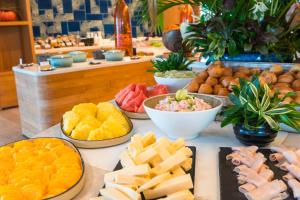 a buffet of different types of food on a table at Hilton Hotel Tahiti in Papeete