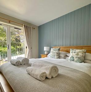 a bedroom with a large bed with towels on it at The Manor at Abberley in Abberley