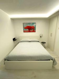 a bedroom with a large bed in a white room at PianoB&b in Campobasso
