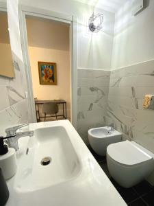 a bathroom with a white sink and a toilet at PianoB&b in Campobasso
