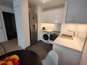 a kitchen with a sink and a stove top oven at Le clos d'Asnières in Asnières-sur-Seine +1 photo