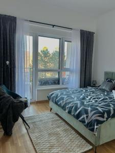 a bedroom with a bed and a large window at Apartman Hera in Vrdnik