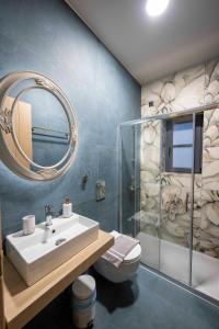 a bathroom with a sink and a shower and a mirror at The five keys in Monodendri