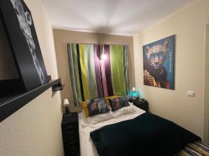 a small bedroom with a bed in a room at *A setting between Dordogne and swimming pool* in Argentat