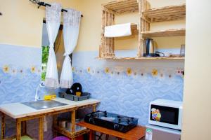 a kitchen with a sink and a counter top at Vibrant Haven ~ Deux in Kilifi