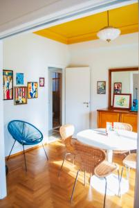 a dining room with a white table and chairs at Dinoulas Penthouse: Renovated Apt in the City Center in Athens