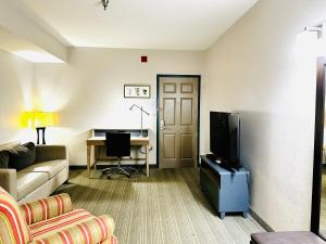 a living room with a couch and a desk at Radiant Inn and Suites in Murfreesboro