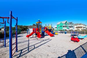a playground in the sand with slides and swings at PC431, Above the Wake- Canalfront, Community Pool, Tennis courts and MORE! in Manteo