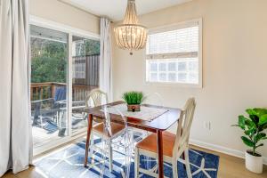 a dining room with a table and chairs and a balcony at Well-Equipped Emerald Isle Townhome Pets Welcome! in Emerald Isle