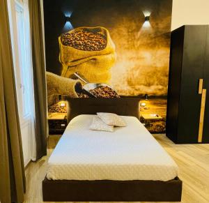 a bedroom with a bed and a wall with a painting at Un Rifugio Accogliente nel Cuore di Bologna - San Felice Relaxing in Bologna