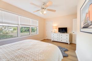 a bedroom with a bed and a ceiling fan at Well-Equipped Emerald Isle Townhome Pets Welcome! in Emerald Isle