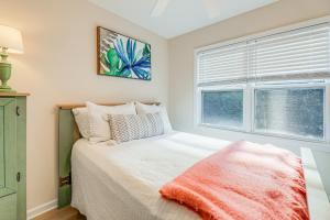 a bedroom with a bed and a window at Well-Equipped Emerald Isle Townhome Pets Welcome! in Emerald Isle