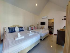 1 dormitorio con 2 camas en una habitación en Raintrary House en Nakhon Phanom