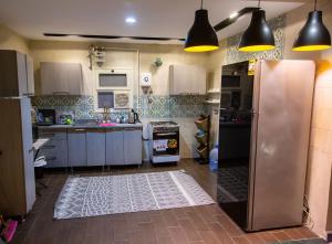 a kitchen with a stainless steel refrigerator in it at Cairo Heliopolis Apartment in Cairo