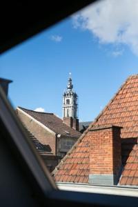 a view of a building with a clock tower at Mons Dragon House in Mons