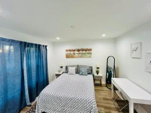 a bedroom with a bed and a desk in it at Modern Home Near Uptown CLT, Airport and More in Charlotte