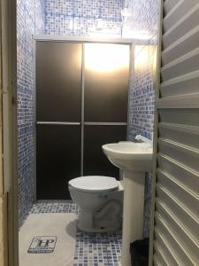 a bathroom with a toilet and a sink at HOTEL PRESIDENTE in Belém