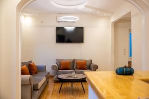 a living room with a couch and a table at Aegli Suites in Livadeia
