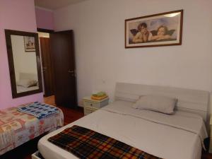 a bedroom with a bed and a picture on the wall at Casa Giulia in Cento