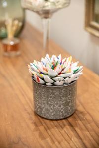 a metal bucket filled with sprinkles on a wooden table at Aegli Suites in Livadeia