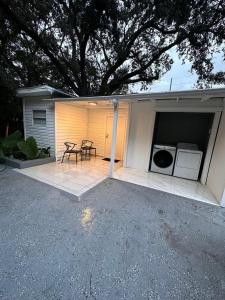 a patio with a washer and dryer in a house at BU2 · Beatiful unit near Adv Island/ BuschGardens in Tampa