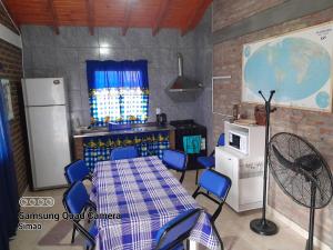 a kitchen with a table and chairs in a room at LO DE MERY in Termas de Río Hondo
