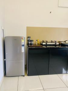 a kitchen with a stove and a refrigerator at KnM Apartment in Kottakkal