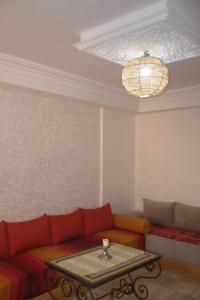 een woonkamer met een bank en een tafel bij Spacious Appartement in Agadir only for families in Agadir