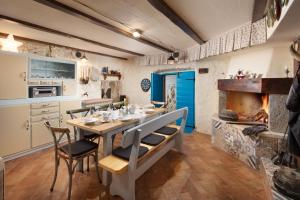 a kitchen with a table and chairs and a stove at Mondinica Heritage House in Dobrinj