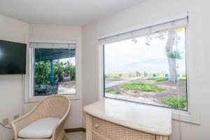 a room with a window and a table and chairs at Azure Seas in Anna Maria
