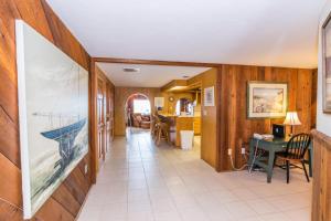 a hallway with wood paneled walls and a dining room at Azure Seas in Anna Maria
