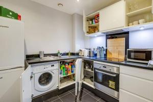 a laundry room with a washer and dryer at Cozy in Colindale/ Balcony in Colindale