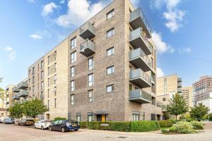 a large brick building with balconies on a street at Cozy in Colindale/ Balcony in Colindale