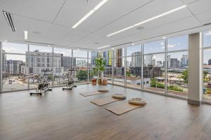 an empty room with a gym with large windows at The Bel Air Suite The Gulch in Nashville