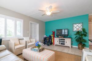 Una sala de estar con un sofá y un televisor. en Anna Maria Beach Place, Unit 3, en Holmes Beach