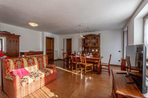 a living room with a couch and a table at CHALET PONTAL 3 - Relax e vista sulle montagne - COUR 0142 in Courmayeur
