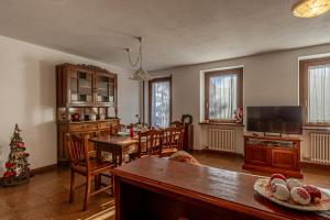a living room with a table and a christmas tree at CHALET PONTAL 3 - Relax e vista sulle montagne - COUR 0142 in Courmayeur +18 photos