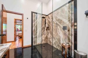 a shower with a glass door in a bathroom at Chapel Vista Main House Red Rock Views and Hot Tub in Sedona