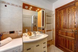 a bathroom with a sink and a mirror at CHALET PONTAL 3 - Relax e vista sulle montagne - COUR 0142 in Courmayeur