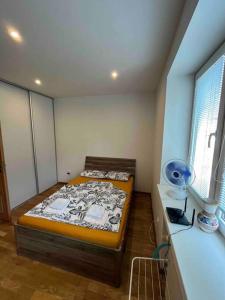a small bedroom with a bed and a window at Brand new apartment in the heart of Bratislava in Bratislava
