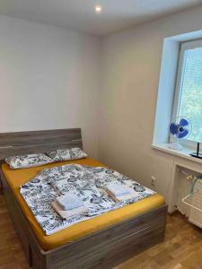 a bedroom with a bed in a room with a window at Brand new apartment in the heart of Bratislava in Bratislava