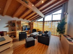 a living room with furniture and a large window at Haus am Römerweg in Lermoos